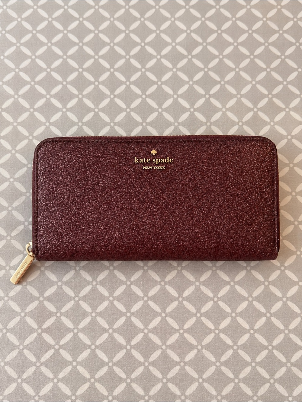 kate spade glitter zip-around wallet in wine